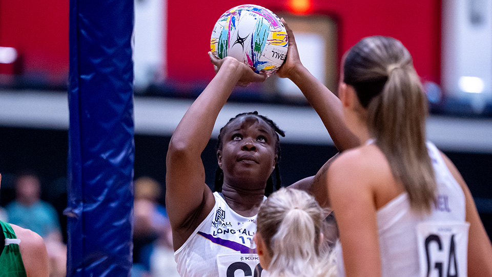 Loughborough Lightning shooter, Samantha Wallace Joseph holding the ball up towards the net on court