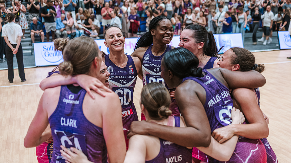 team celebrating in a huddle