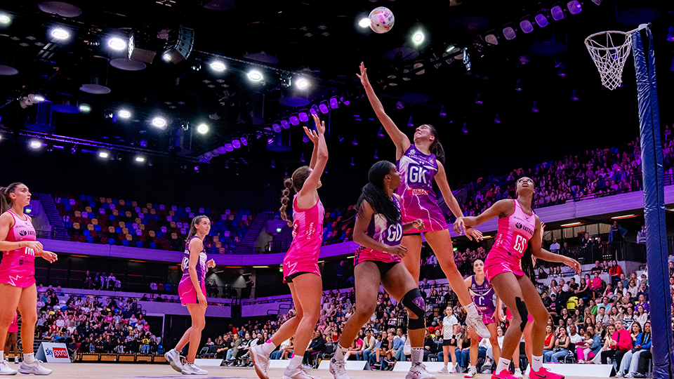 Alice Harvey jumping to block a shot from Pulse shooter