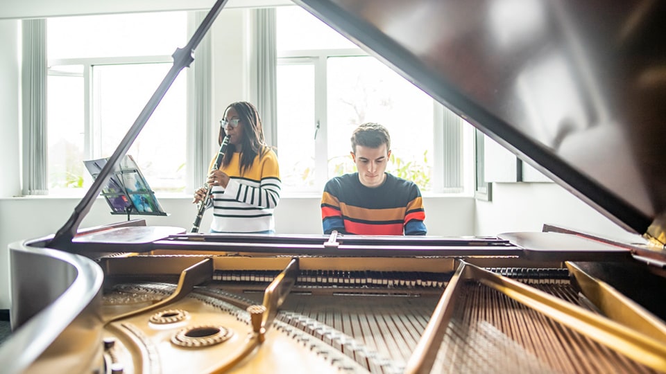 Students playing clarinet and piano