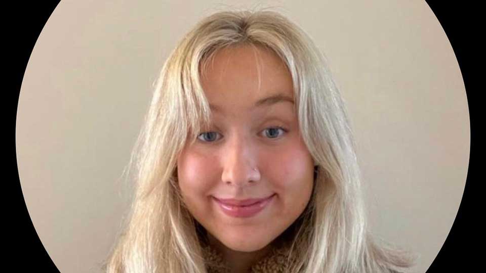 Headshot of female student in early twenties with long straight blonde hair smiling