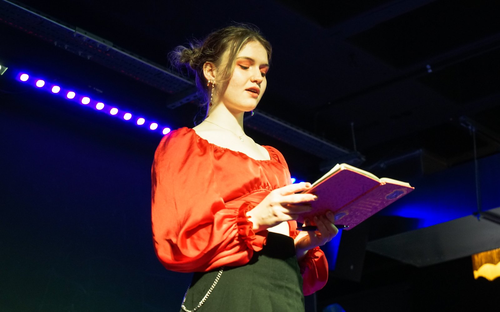 A student performing on stage at an LU Arts Speech Bubble event