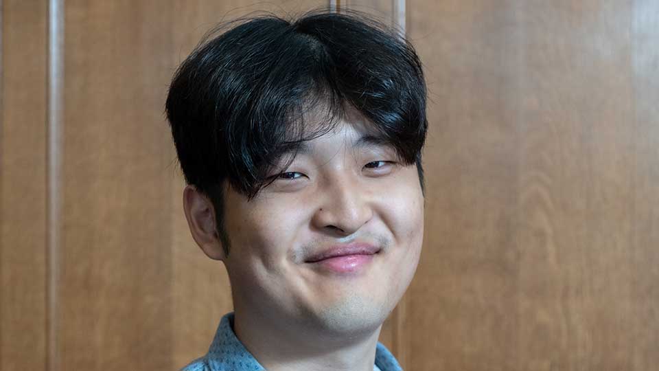Young male of Asian ethnicity in early twenties with short dark hair