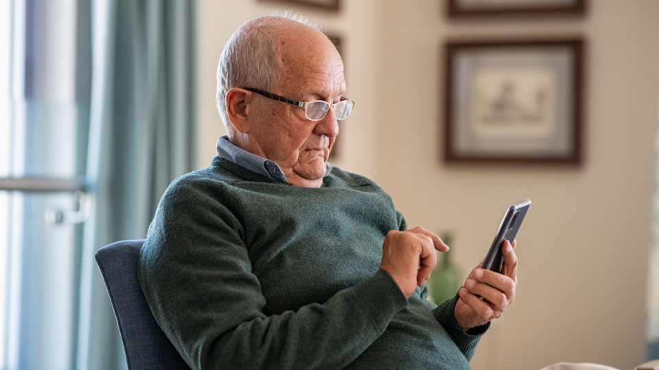 An old man on his phones
