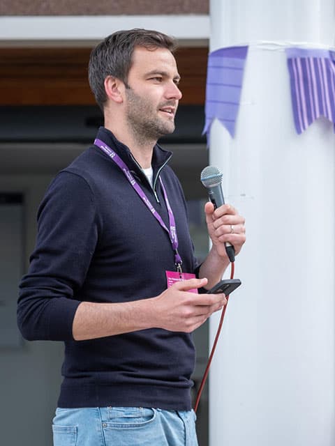 Someone delivering a speech using a microphones.