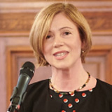Clara Neppel standing in front of a microphones