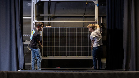 2 students holding solar panel