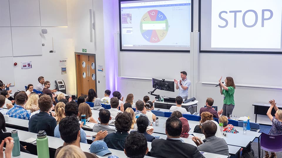 Summer showcase 2025 presentation. The image shows the audience and two presenters in front of screens