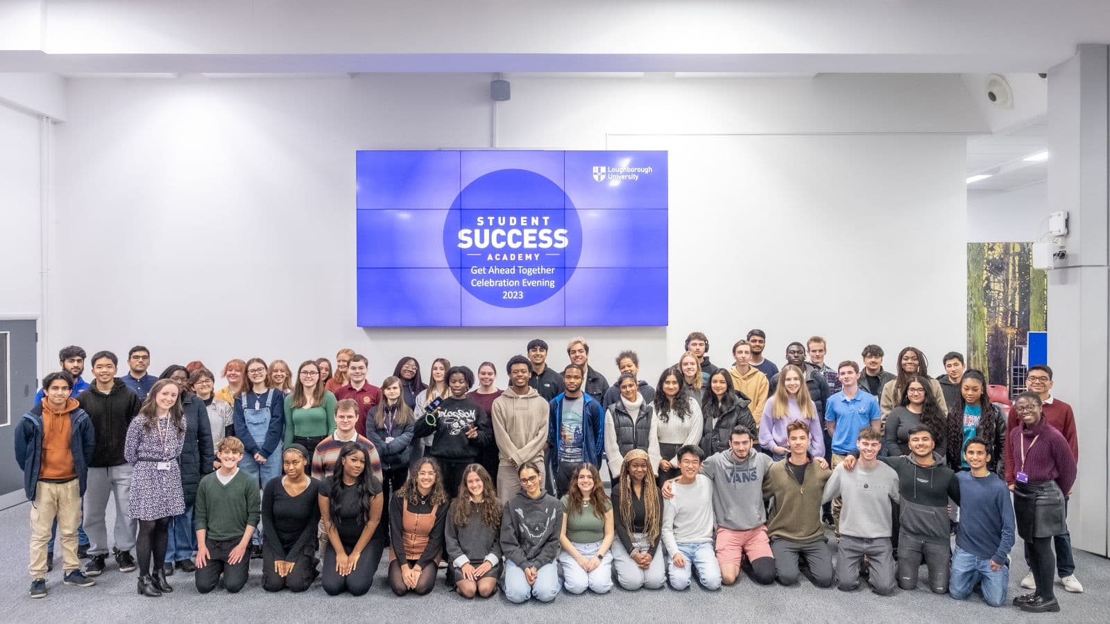 Group photo of approximately 60 attendees at Get ahead together celebration evening 2023