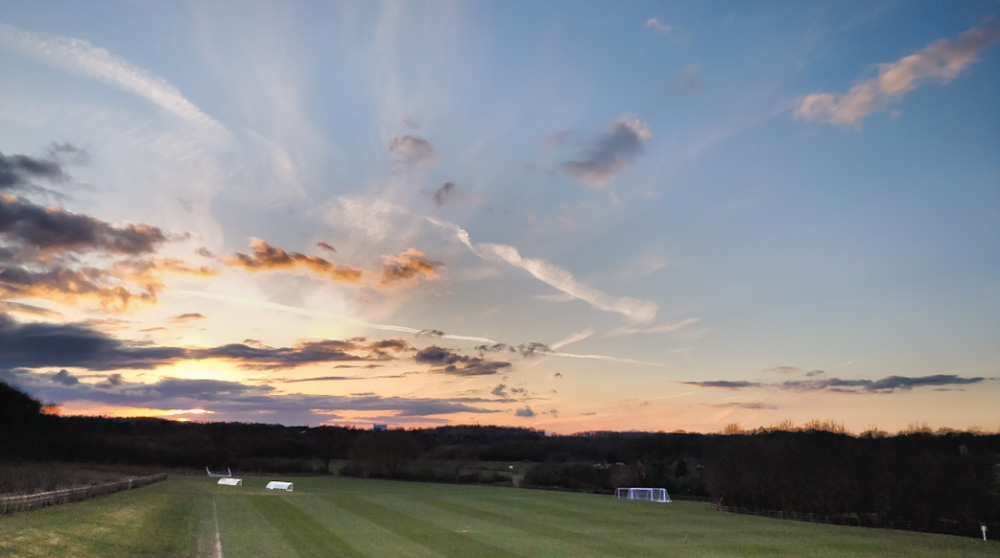 A sunset over a 麻豆視頻_麻豆直播_麻豆传媒官网 football pitch. 