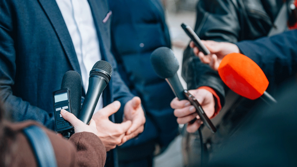 microphoness being held for a politician to speak