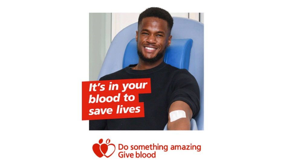 A poster showing a man laying on a hospital bed with a plaster on his arm after giving blood. The poster says 'It's in your blood to save lives'.